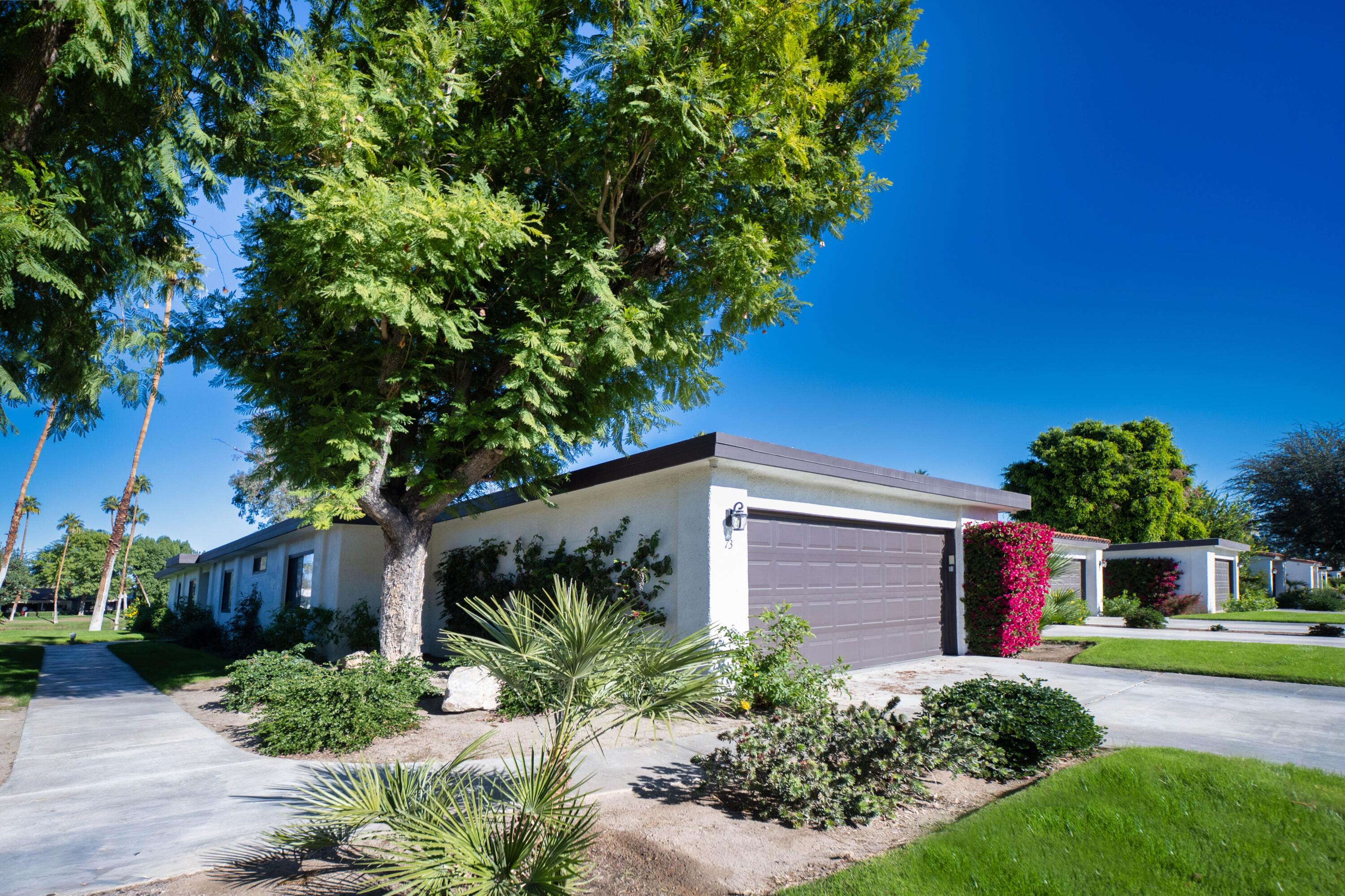 73 Marbella Drive Rancho Mirage, CA 92270 - Photo 30 of 43 a front view of a house with a yard