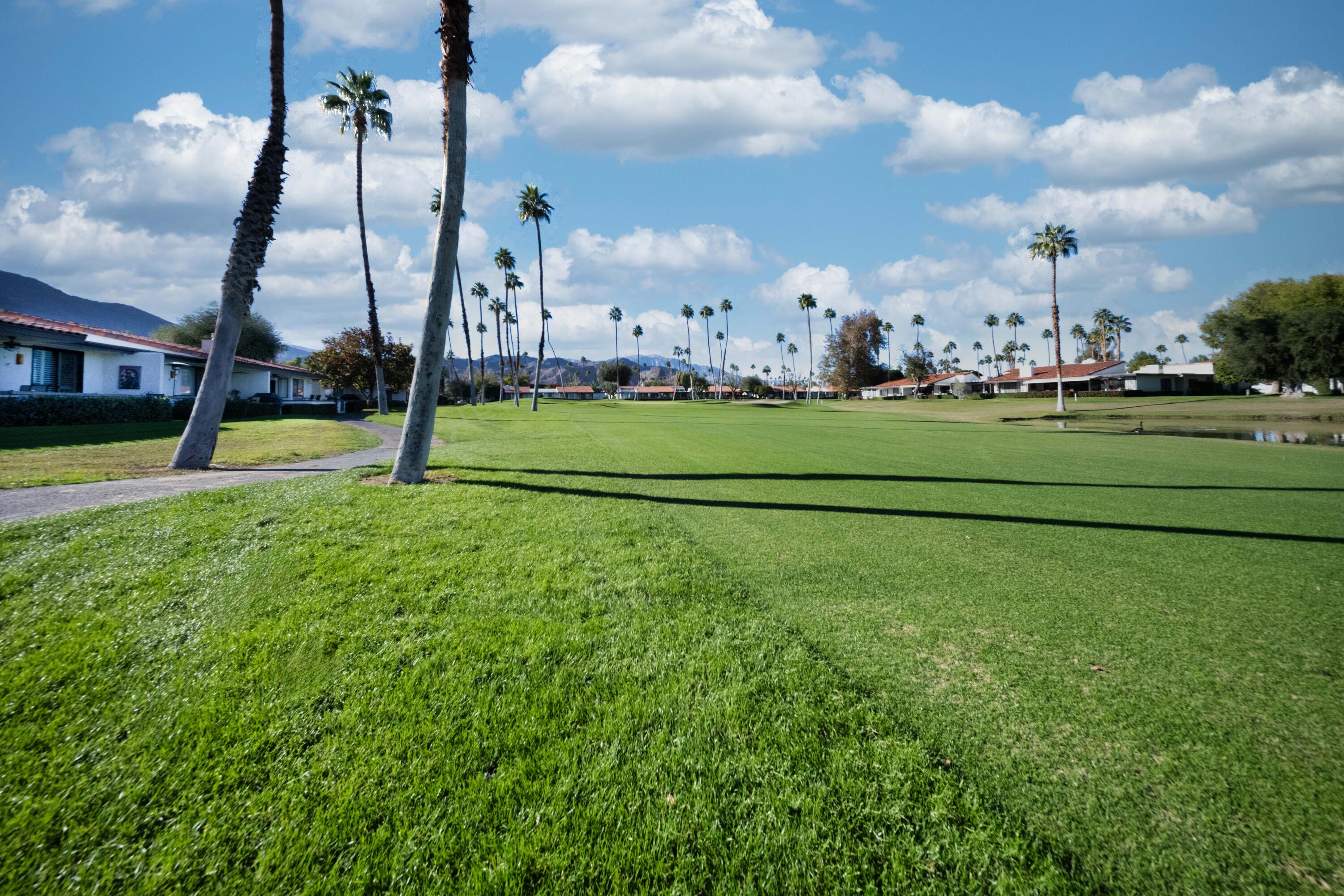 73 Marbella Drive Rancho Mirage, CA 92270 - Photo 42 of 43 a view of an apartment building and trees in the background