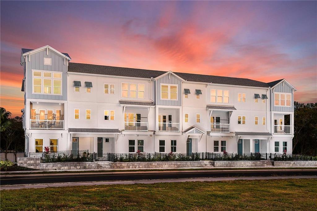 413 Gowdy Road Sarasota, FL 34237 - Photo 1 of 1 a front view of a building with river and trees in the background