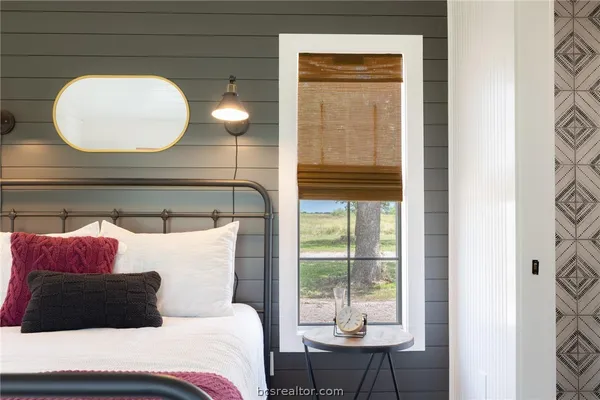 a bedroom with a bed and a chandelier