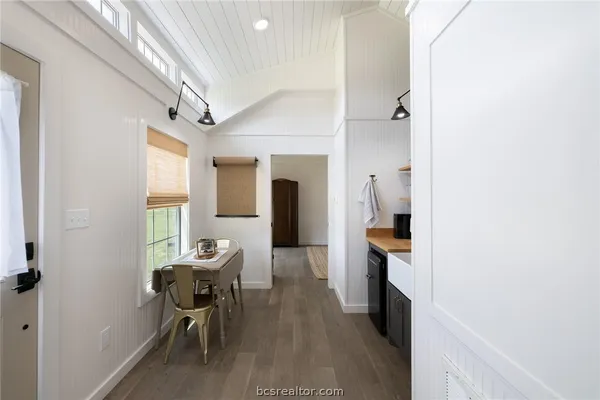a hallway with furniture and wooden floor