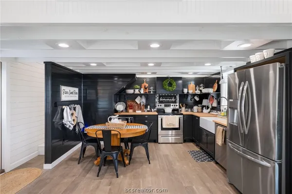 a kitchen with a table and chairs in it