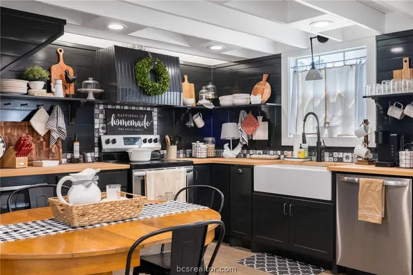 a kitchen with stainless steel appliances granite countertop a sink and cabinets
