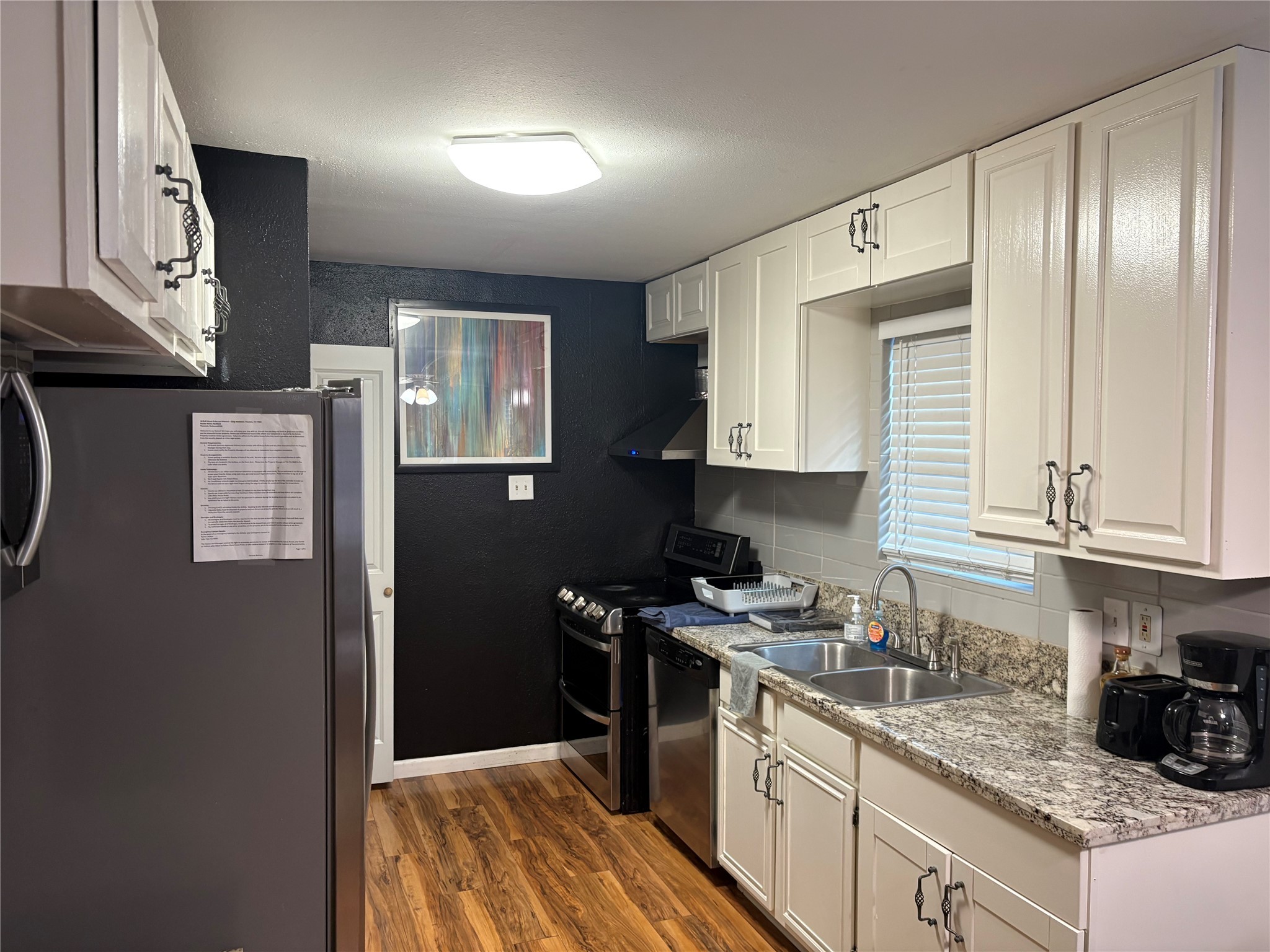 2201 Nettleton Street Houston, TX 77004 - Photo 16 of 21 a kitchen with stainless steel appliances granite countertop a stove a sink and a refrigerator