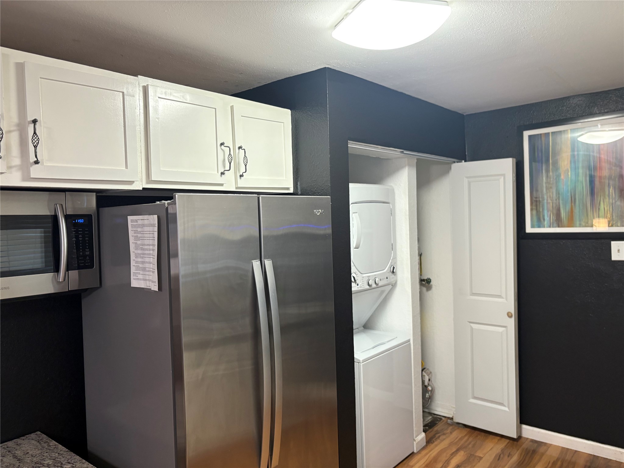 2201 Nettleton Street Houston, TX 77004 - Photo 17 of 21 a metallic refrigerator freezer sitting inside of a kitchen