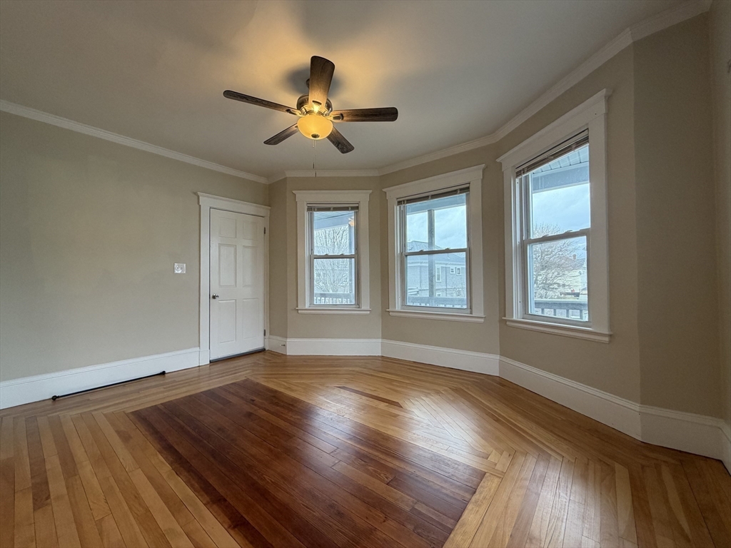 320 Wood Street, Unit 2 New Bedford, MA 02745 - Photo 1 of 23 a view of empty room with wooden floor and fan