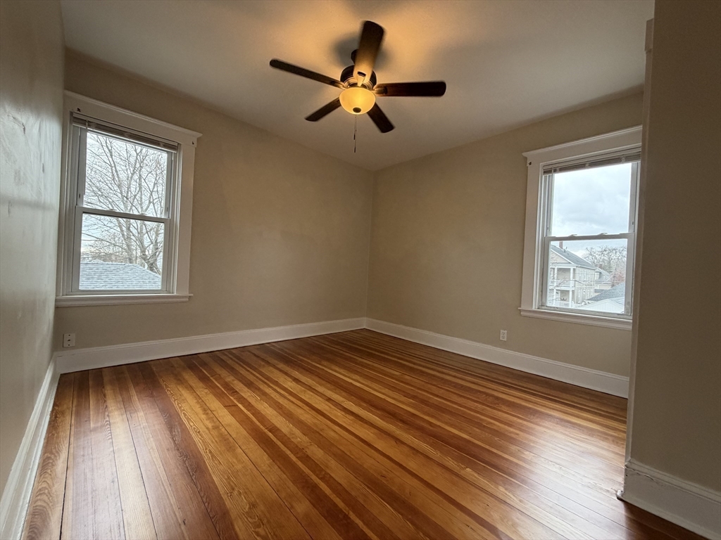 320 Wood Street, Unit 2 New Bedford, MA 02745 - Photo 13 of 23 a view of an empty room with wooden floor and a window