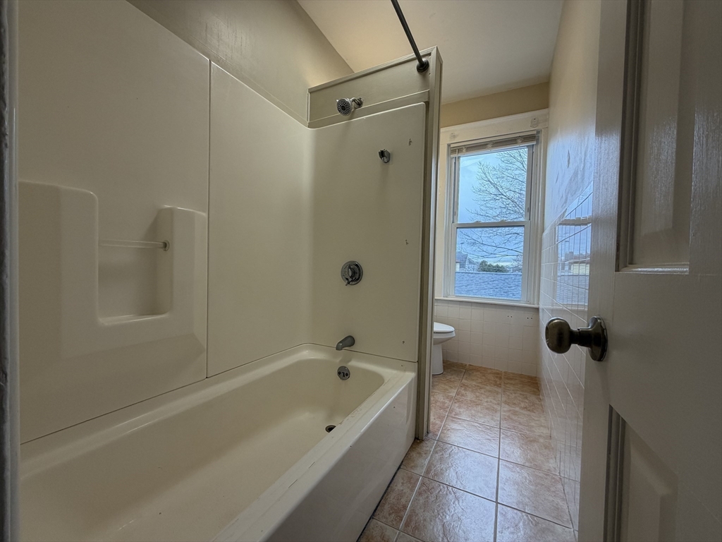 320 Wood Street, Unit 2 New Bedford, MA 02745 - Photo 15 of 23 a bathroom with a bathtub and shower
