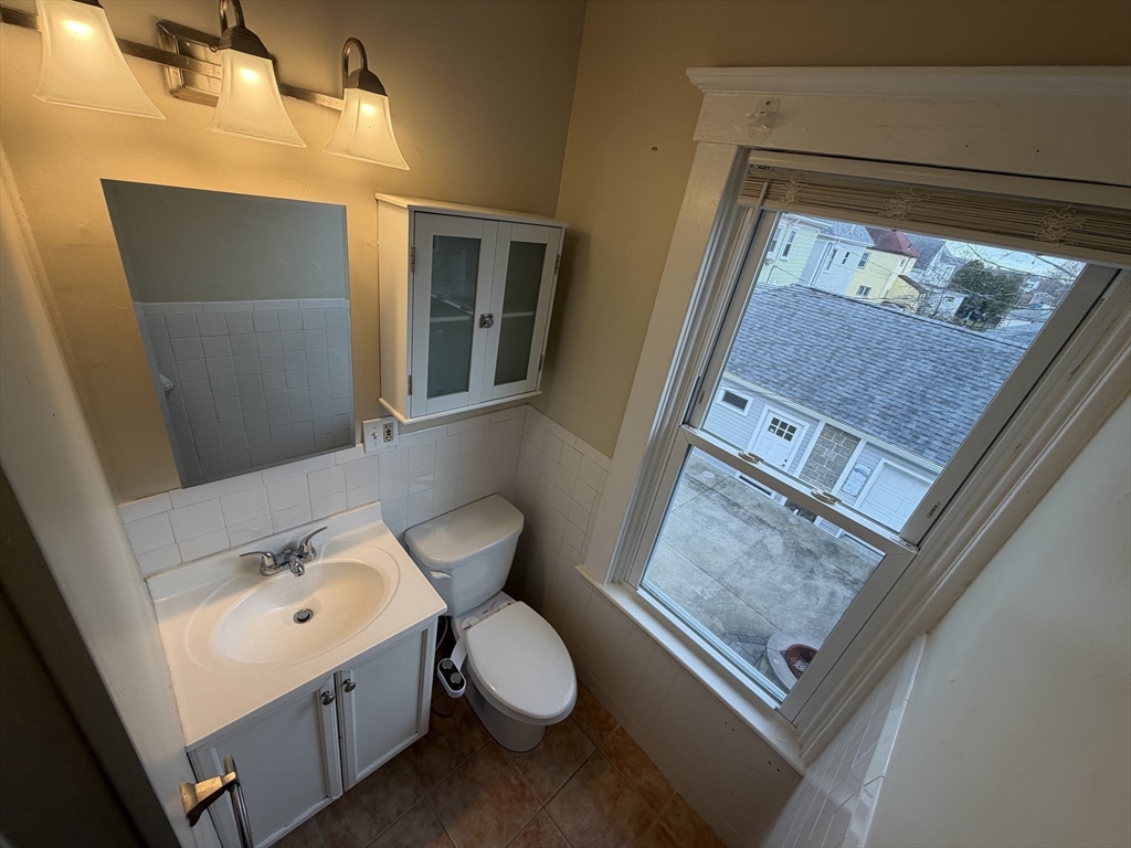 320 Wood Street, Unit 2 New Bedford, MA 02745 - Photo 16 of 23 a bathroom with a toilet sink and mirror