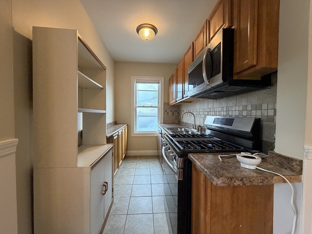 320 Wood Street, Unit 2 New Bedford, MA 02745 - Photo 17 of 23 a kitchen with a stove and a microwave
