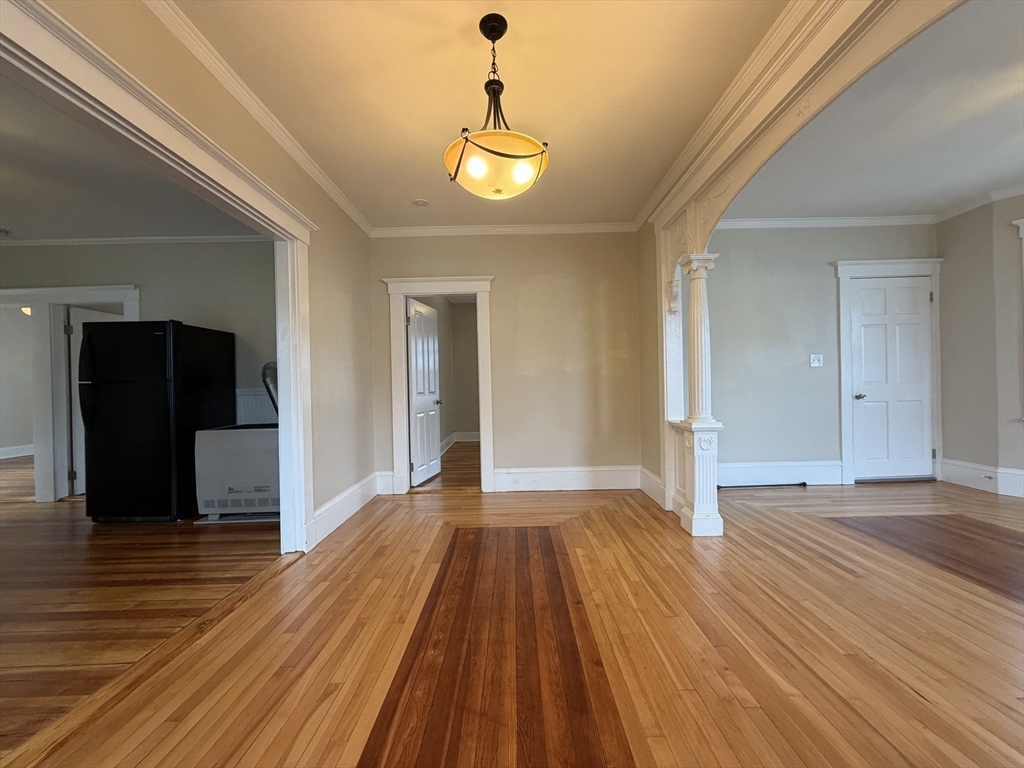 320 Wood Street, Unit 2 New Bedford, MA 02745 - Photo 5 of 23 a view of an empty room with wooden floor