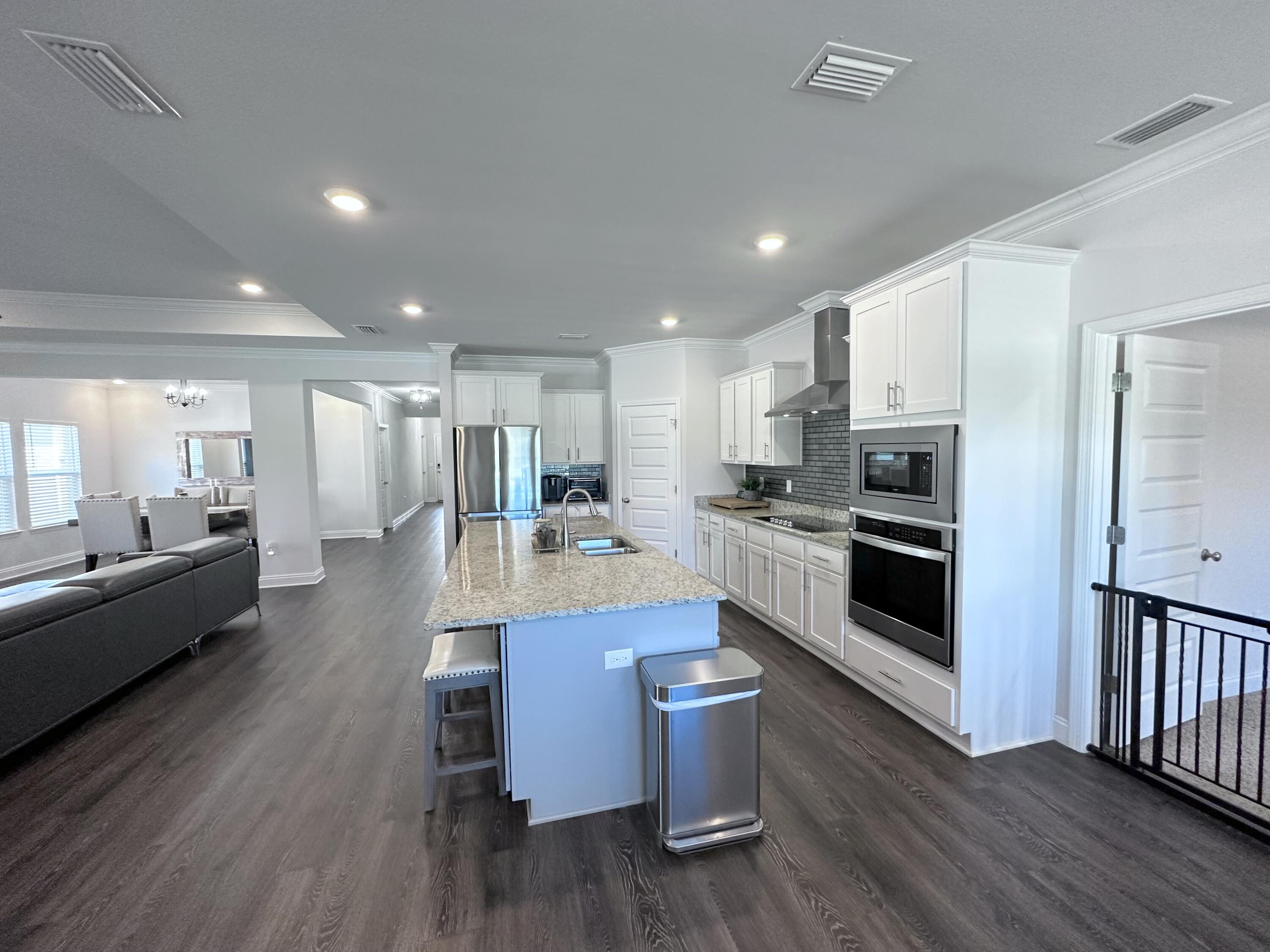 165 Martingale Loop Lynn Haven, FL 32444 - Photo 11 of 37 a large kitchen with a table and stainless steel appliances