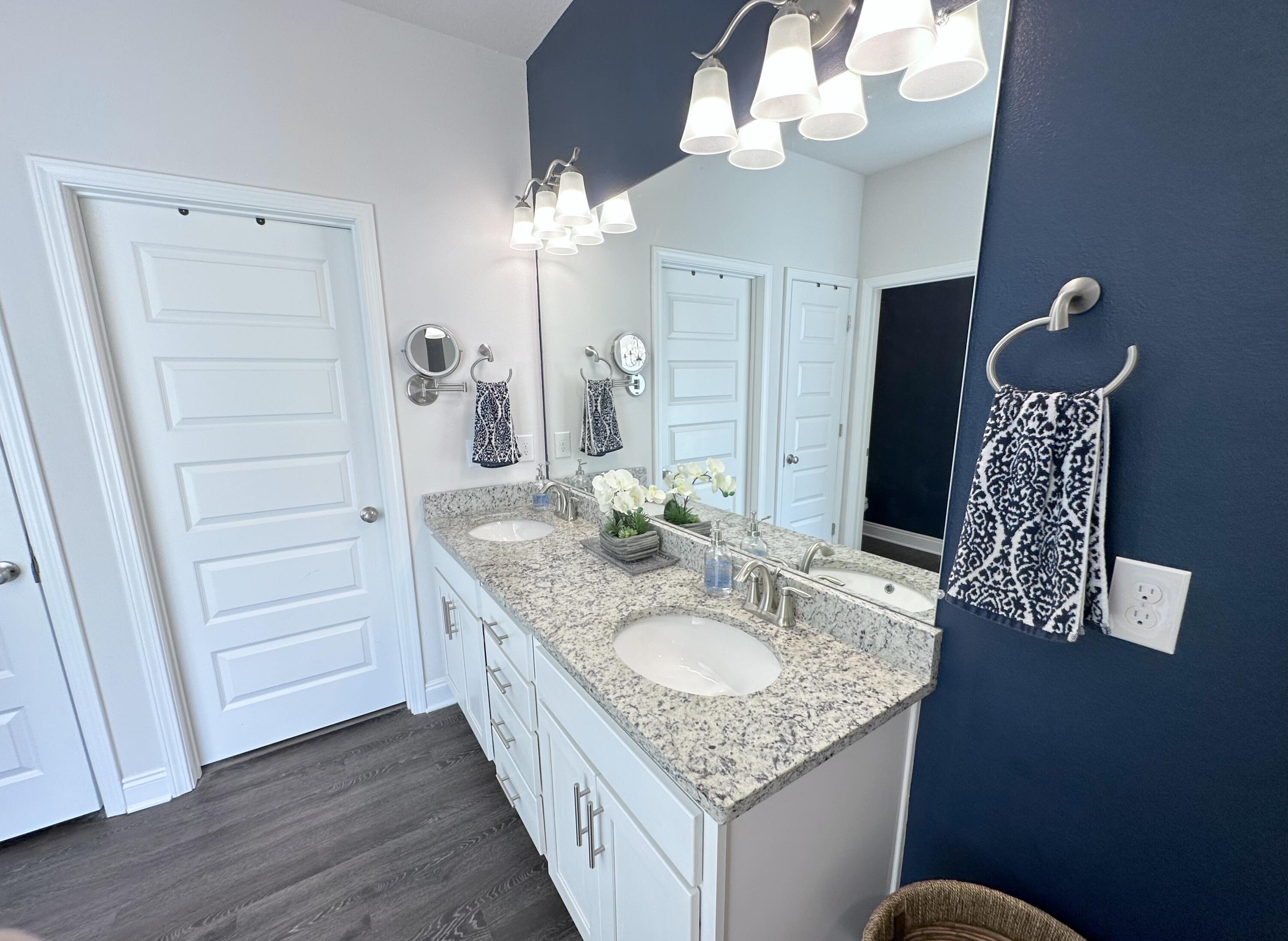 165 Martingale Loop Lynn Haven, FL 32444 - Photo 15 of 37 a bathroom with a granite countertop sink a mirror and a shower