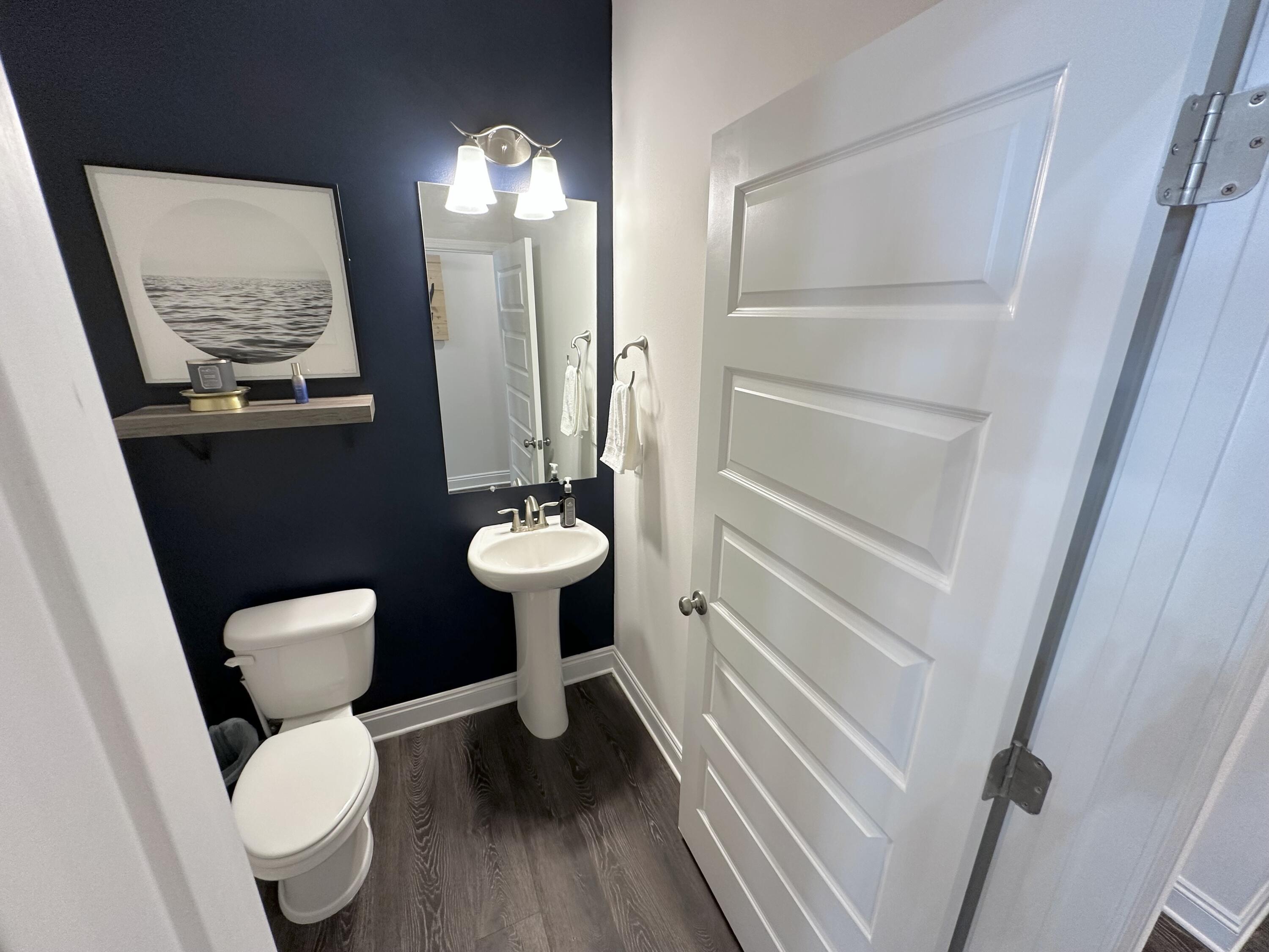 165 Martingale Loop Lynn Haven, FL 32444 - Photo 17 of 37 a bathroom with a toilet sink and mirror