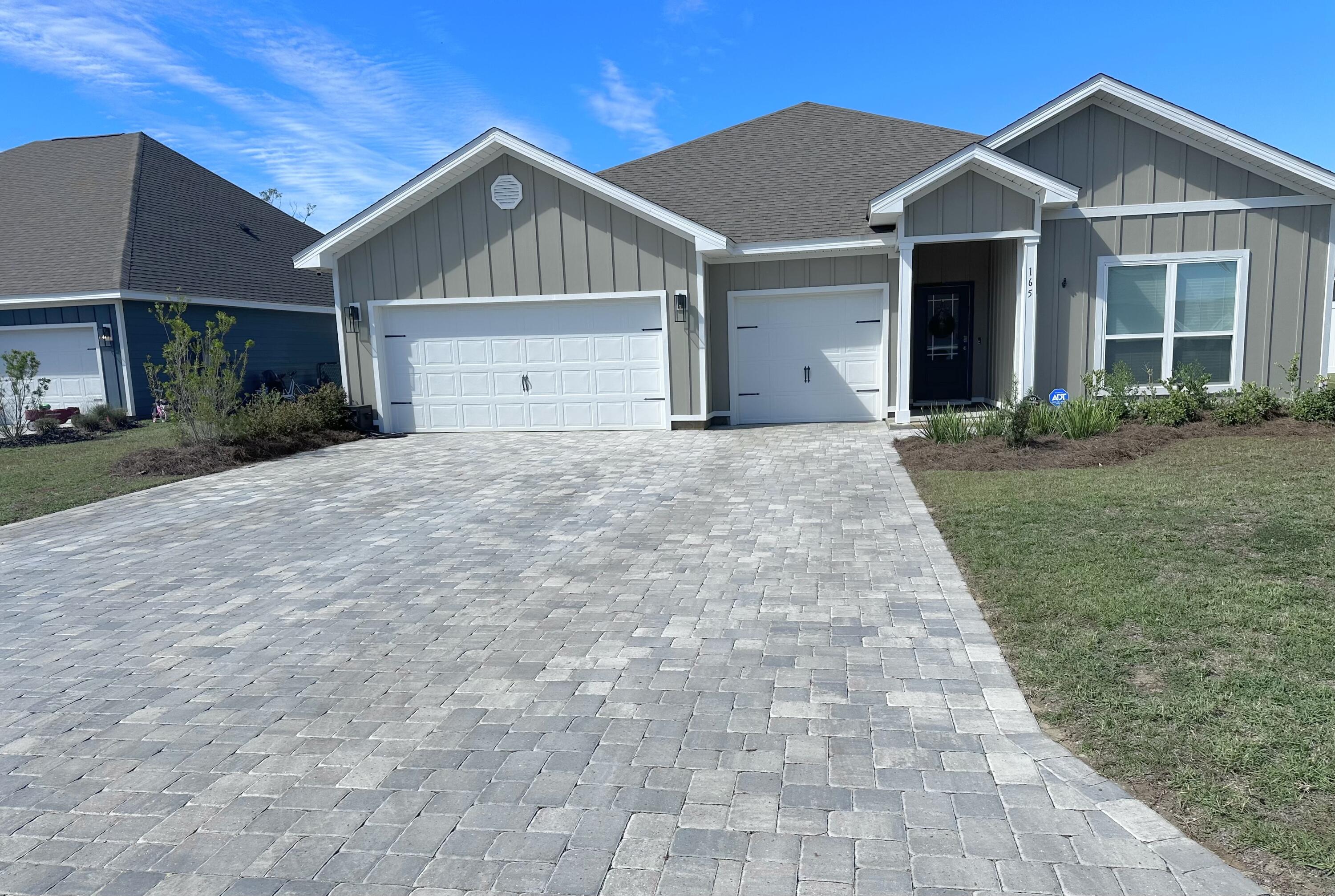 165 Martingale Loop Lynn Haven, FL 32444 - Photo 2 of 37 a front view of a house with a yard and garage