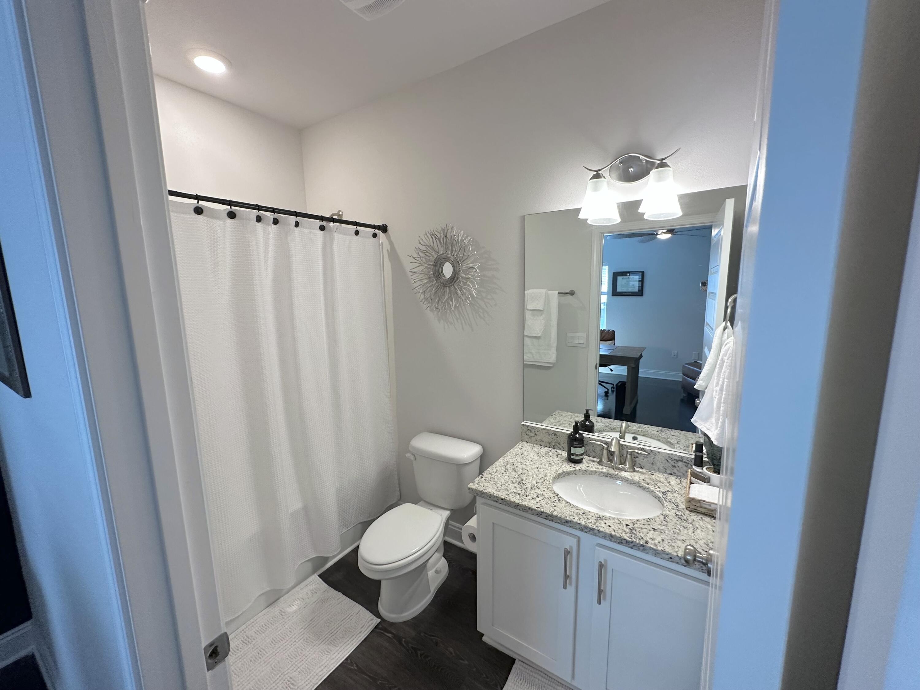 165 Martingale Loop Lynn Haven, FL 32444 - Photo 21 of 37 a bathroom with a granite countertop sink toilet and shower
