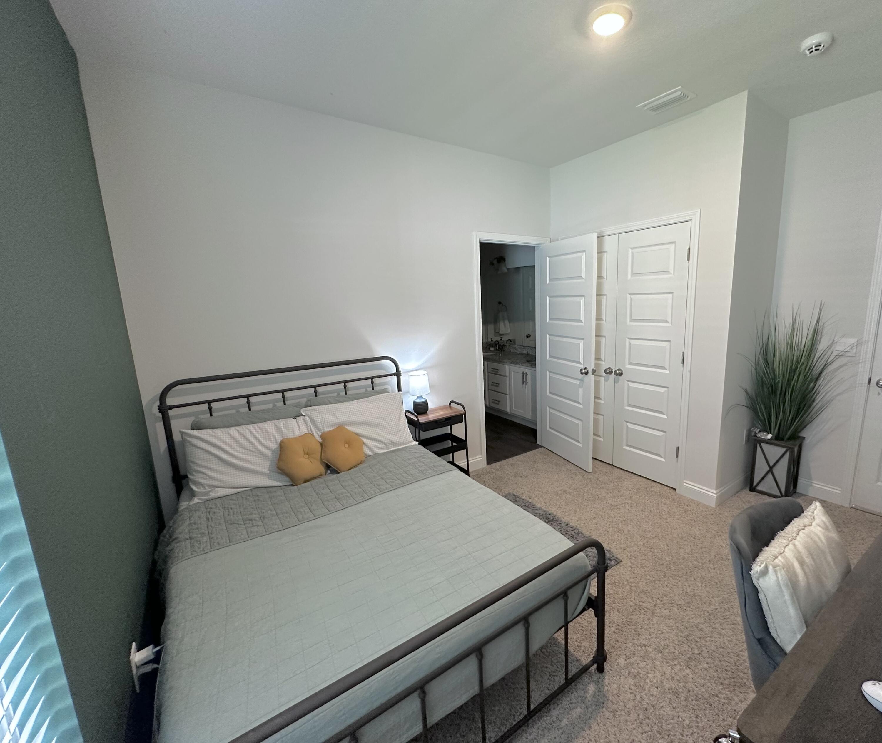 165 Martingale Loop Lynn Haven, FL 32444 - Photo 23 of 37 a bedroom with furniture and a potted plant