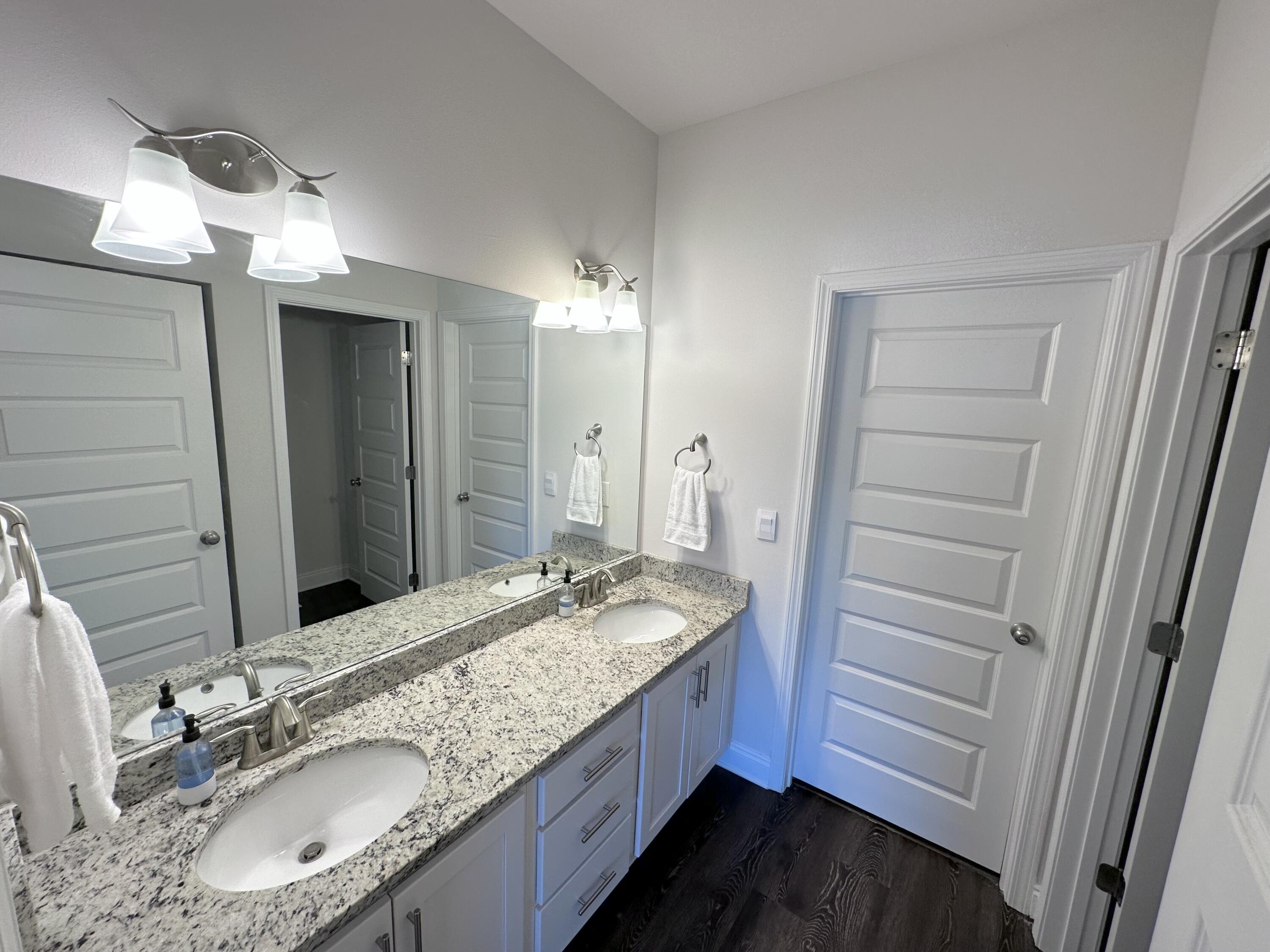 165 Martingale Loop Lynn Haven, FL 32444 - Photo 26 of 37 a bathroom with a granite countertop sink double vanity and a mirror