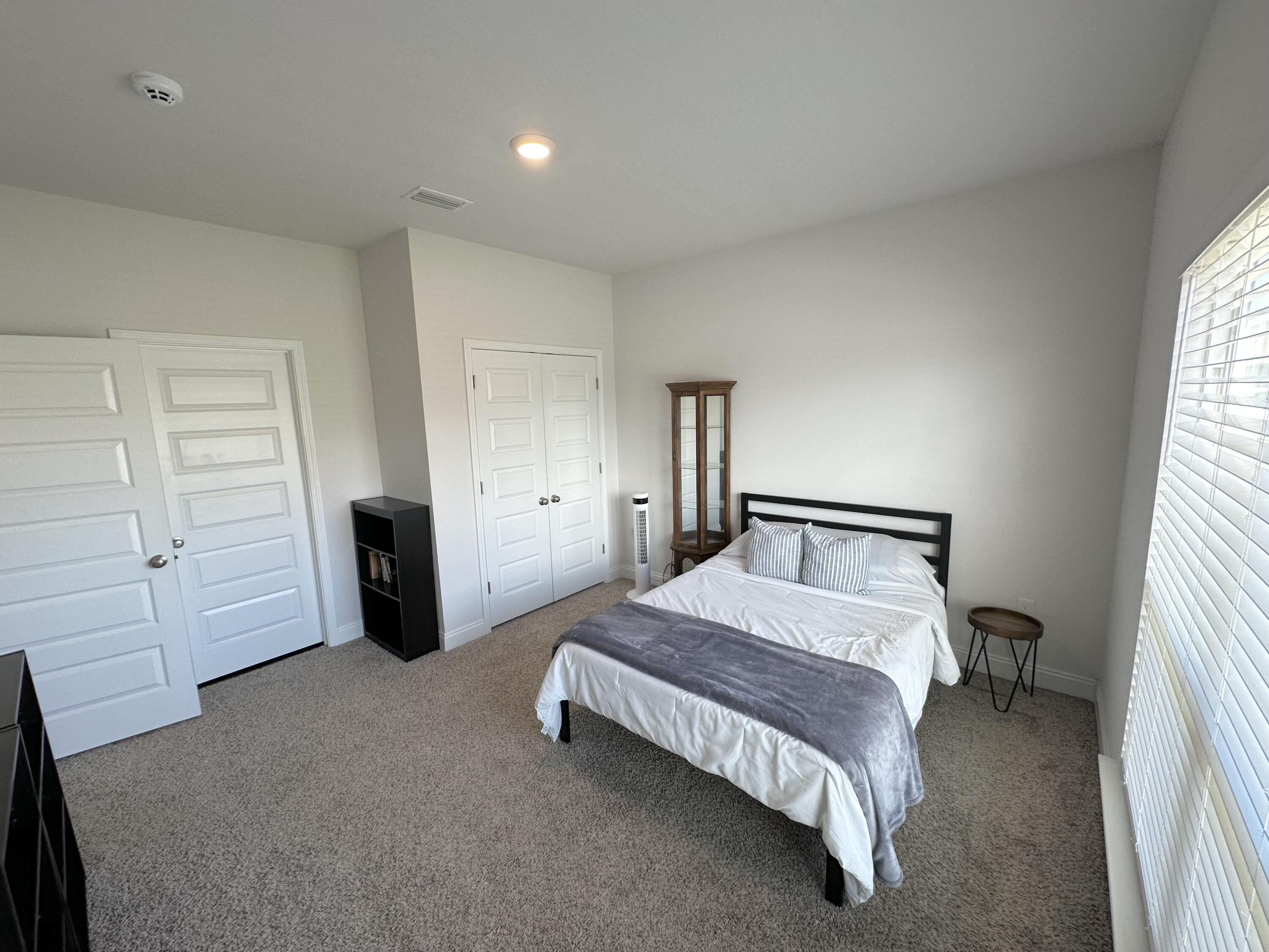 165 Martingale Loop Lynn Haven, FL 32444 - Photo 29 of 37 a spacious bedroom with a bed and a closet