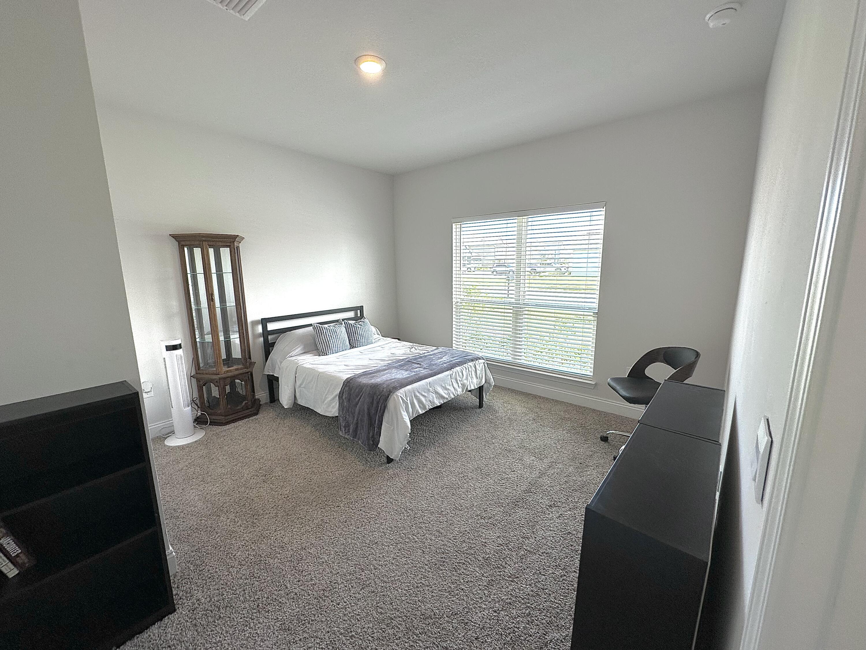 165 Martingale Loop Lynn Haven, FL 32444 - Photo 30 of 37 a spacious bedroom with a bed and a window