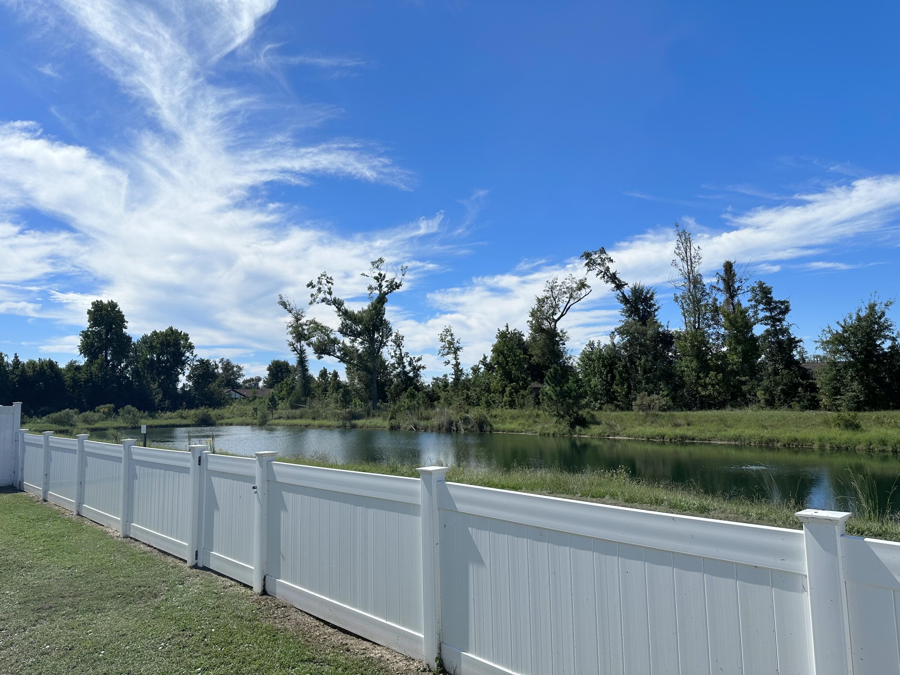 165 Martingale Loop Lynn Haven, FL 32444 - Photo 34 of 37 a view of a lake with houses in the back