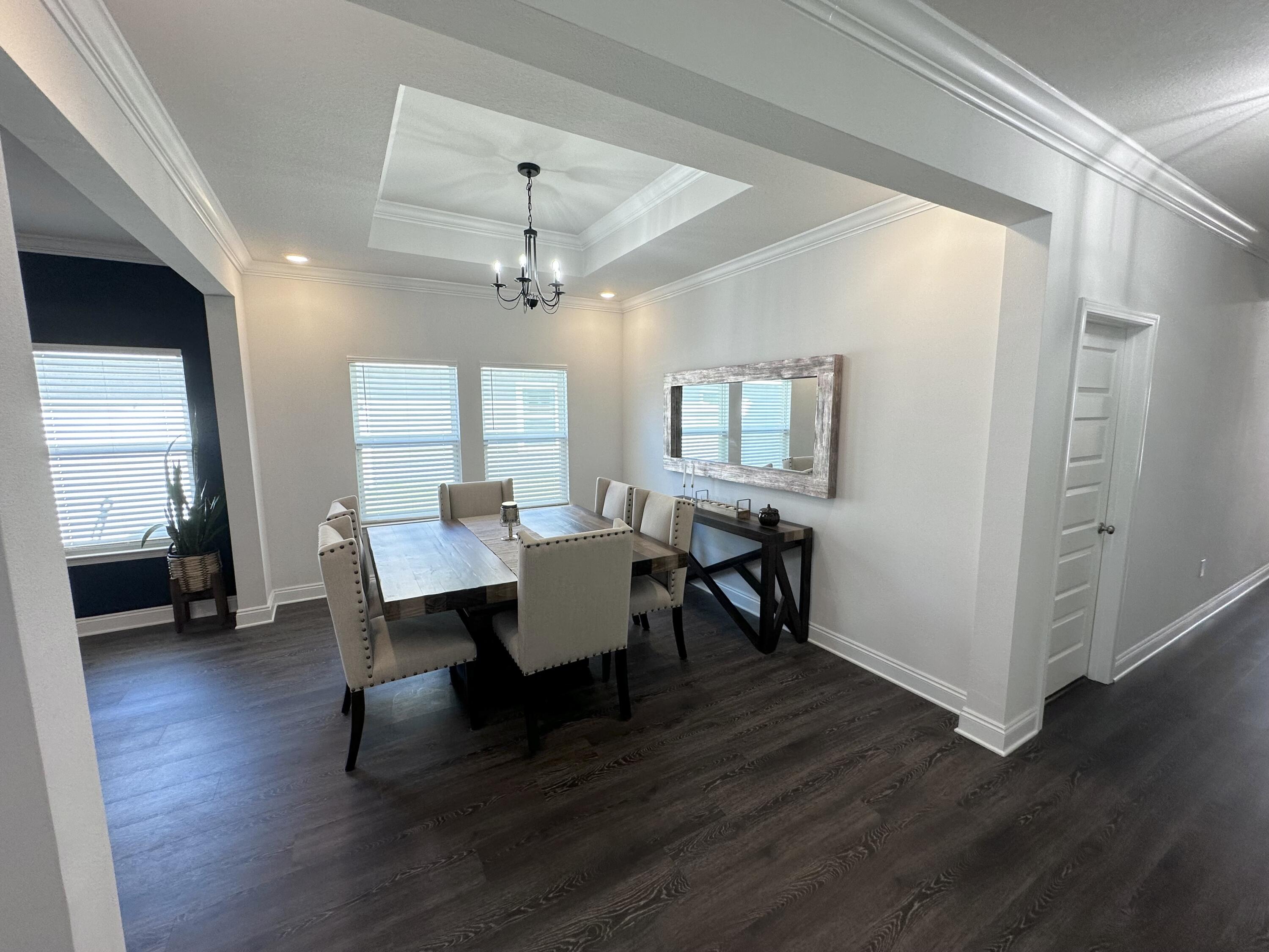 165 Martingale Loop Lynn Haven, FL 32444 - Photo 4 of 37 a view of a dining room with furniture and wooden floor