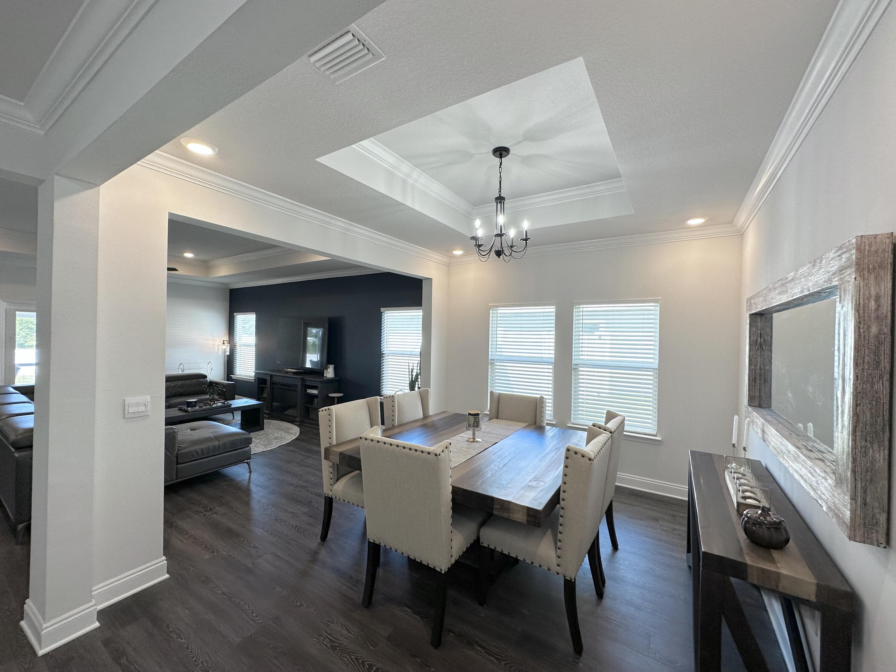 165 Martingale Loop Lynn Haven, FL 32444 - Photo 6 of 37 a view of a dining room with furniture wooden floor and chandelier
