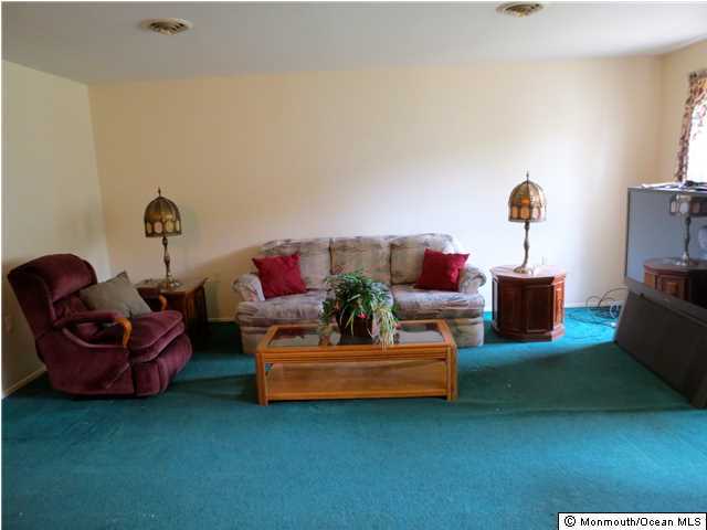 29B Stonybrook Road, Unit A Whiting, NJ 08759 - Photo 3 of 9 a living room with furniture and a mirror
