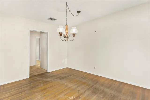 a view of a chandelier fan and wooden floor