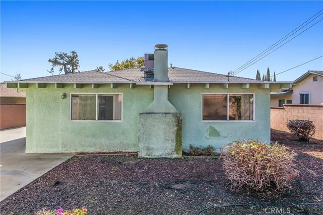 a view of a yard with wooden fence