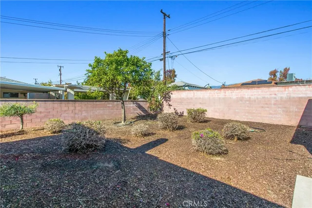 a backyard of a house with barbeque oven fire pit table and chairs