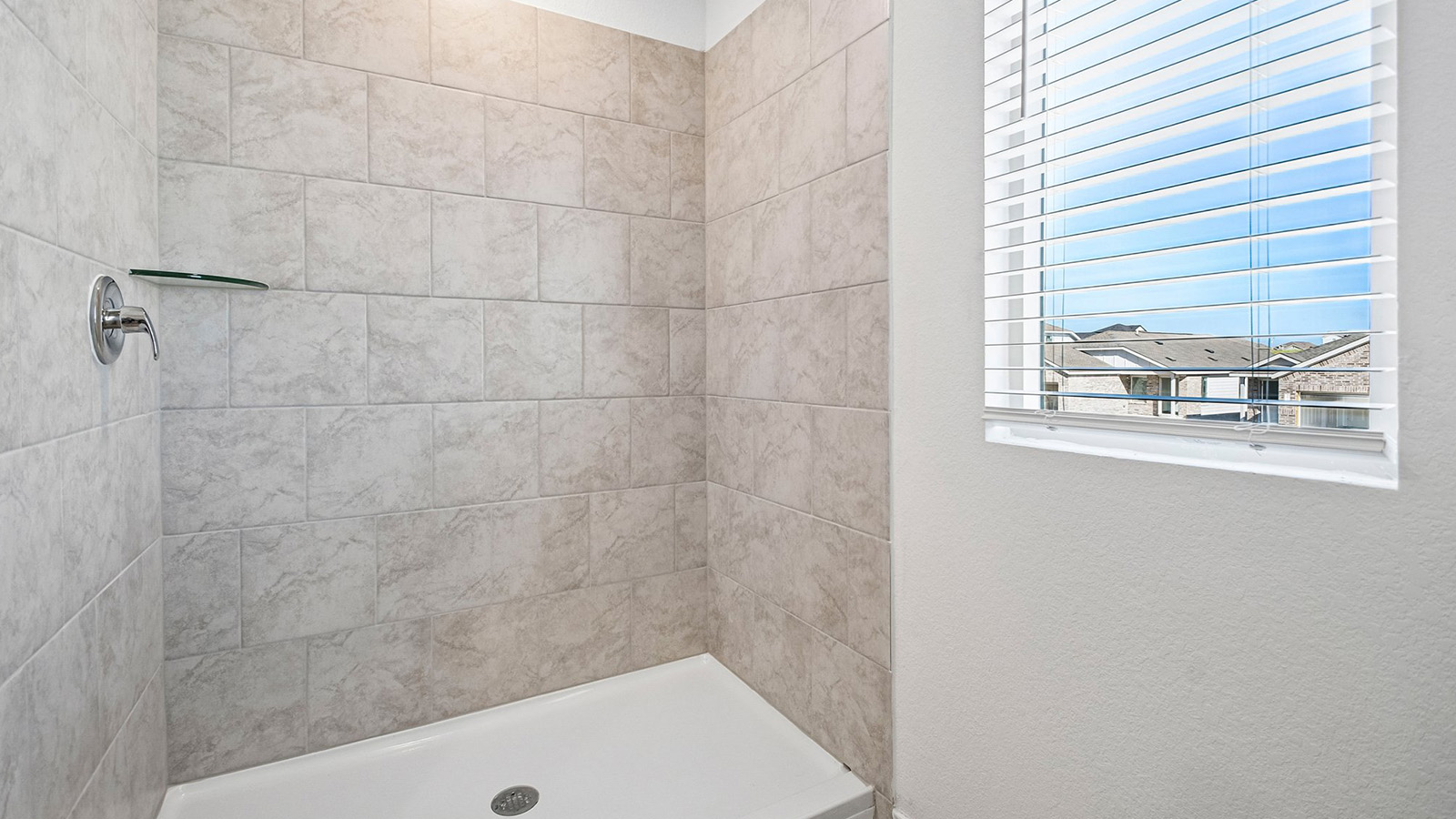 388 Old Stage Coach Road Jarrell, TX 76537 - Photo 19 of 30 Tiled walls surround this walk-in shower situated adjacent to a bright window.