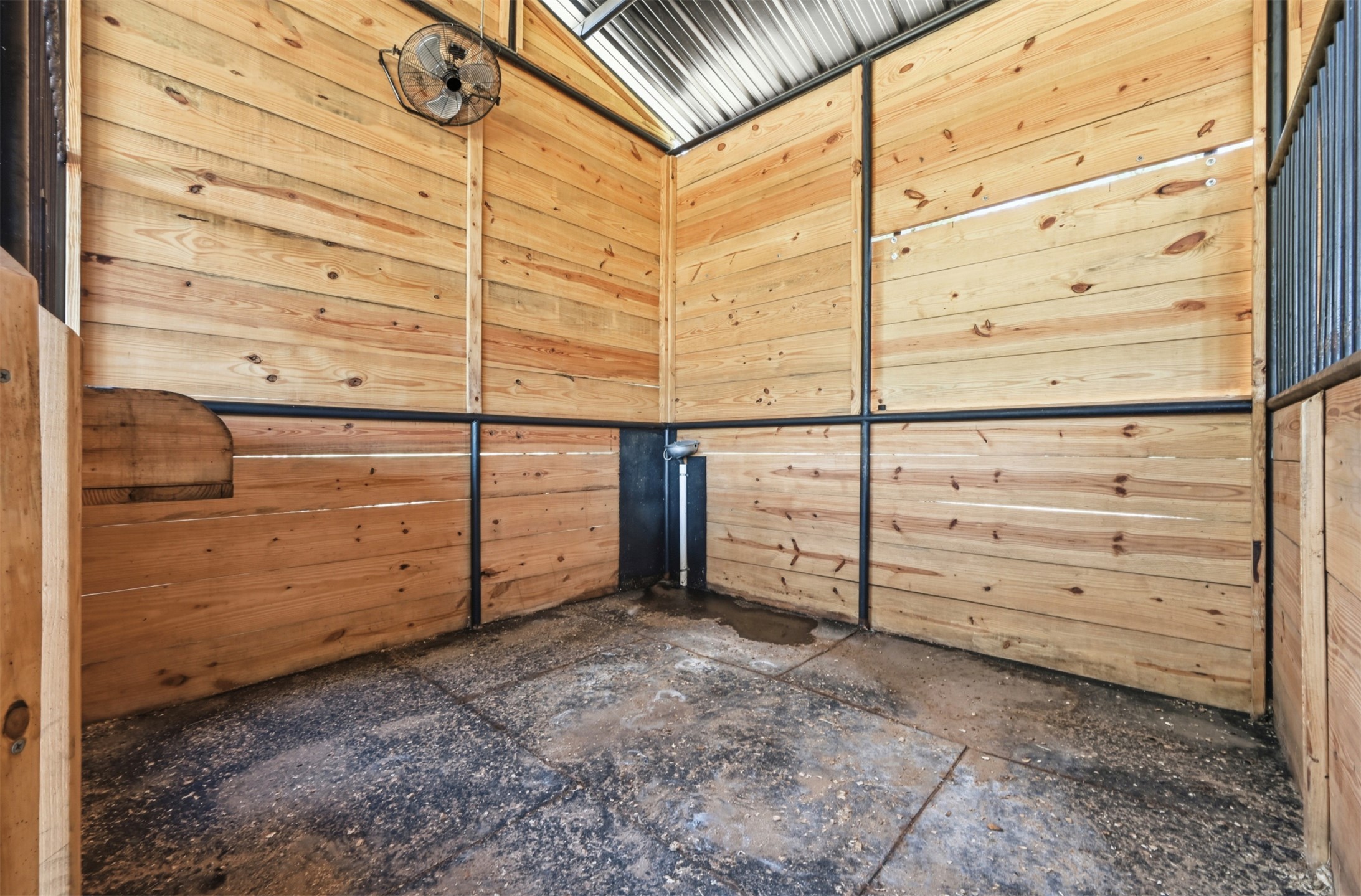 387 Corral Road Smithville, TX 78957 - Photo 36 of 40 Interior space featuring natural wood paneling, a corrugated metal ceiling, and black metal framing