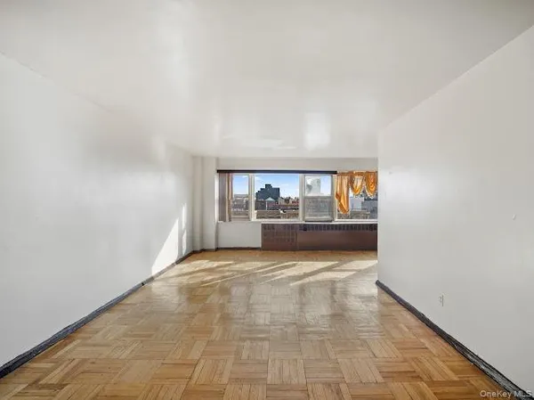 a kitchen with a refrigerator a stove and white cabinets
