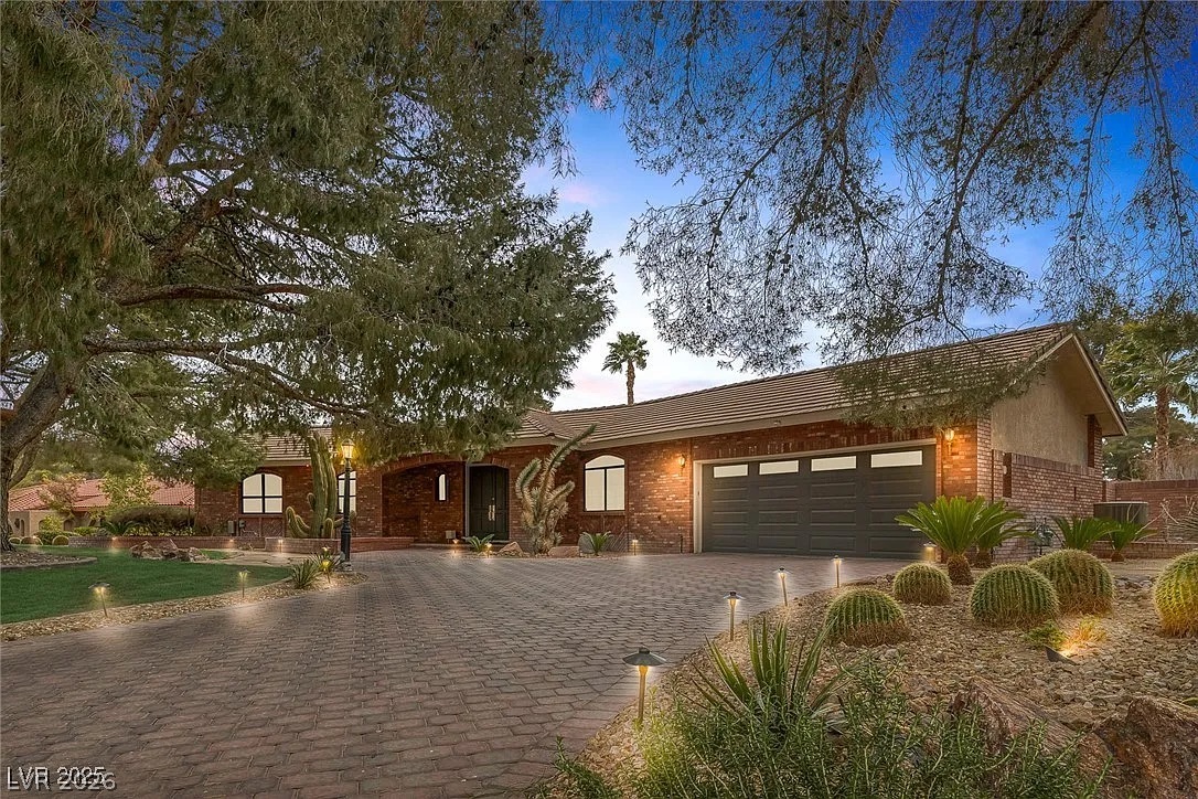 9 Quail Run Road Henderson, NV 89014 - Photo 1 of 57 A desert oasis welcomes you home with a paver driveway, mature trees, and thoughtful landscape lighting.
