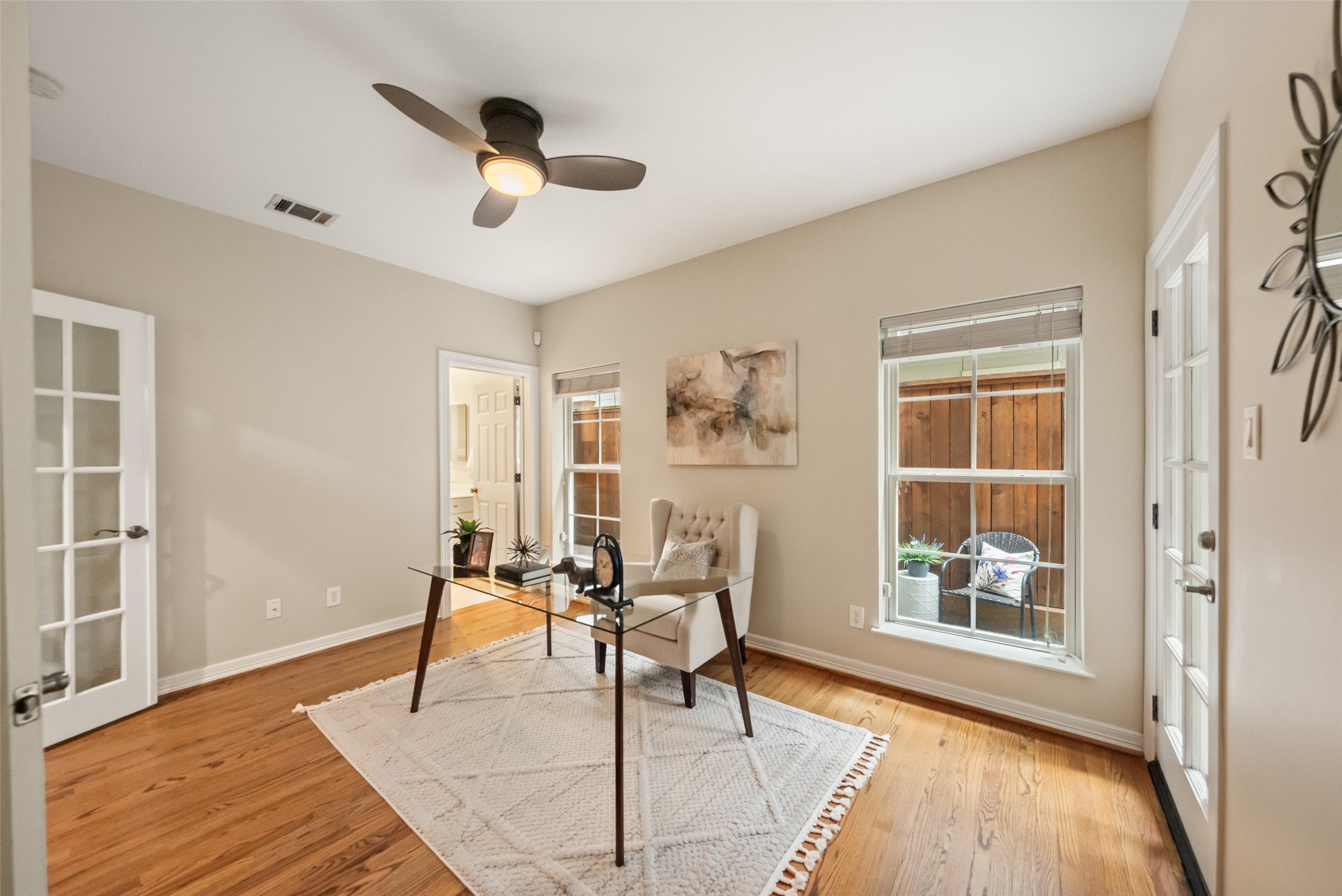 2708 Wroxton Road West University Place, TX 77005 - Photo 9 of 22 This bright home office features elegant French doors, warm hardwood floors, and ample natural light, creating an inspiring and productive workspace.
