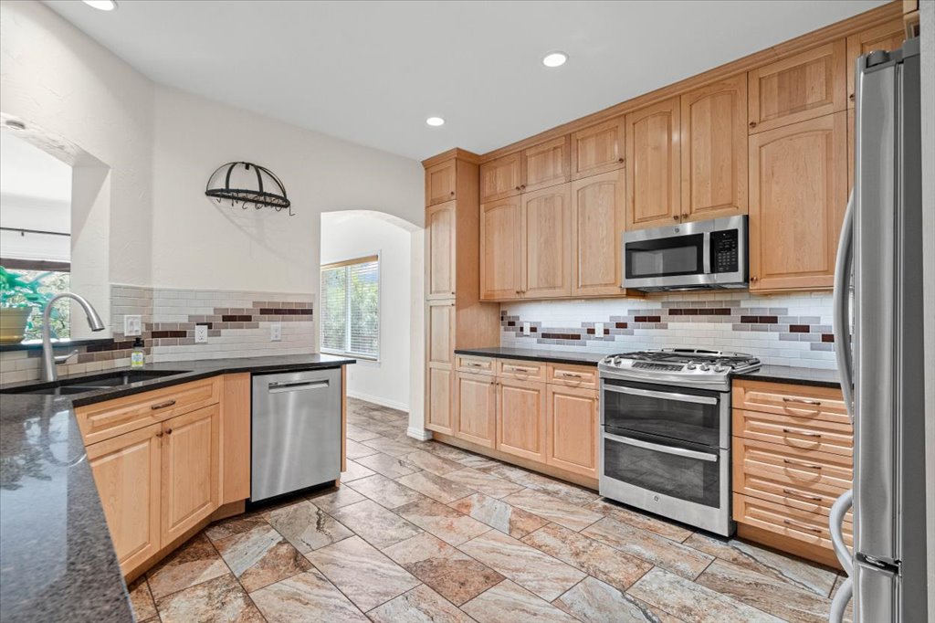 37 Pillow Road Austin, TX 78745 - Photo 6 of 18 Culinary adventures await in this kitchen featuring abundant wood cabinetry and sophisticated tile flooring.