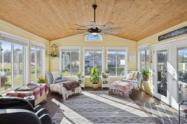 a bedroom with furniture and large windows