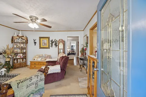 a living room with furniture and a chandelier