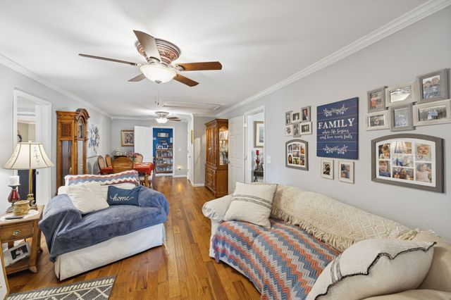 a living room with furniture and a chandelier