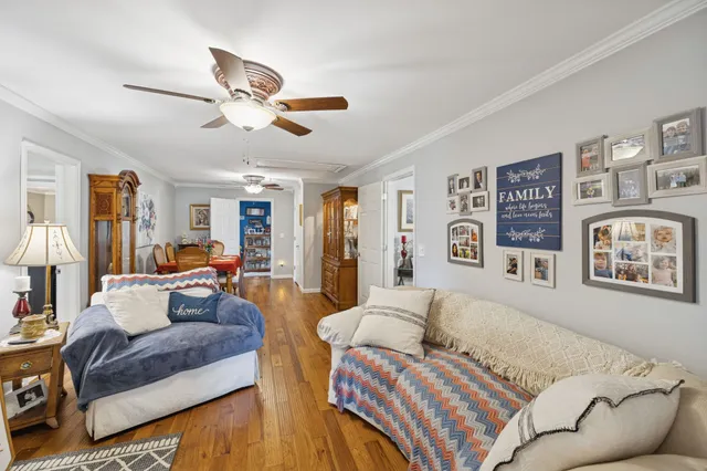 a living room with furniture and a chandelier