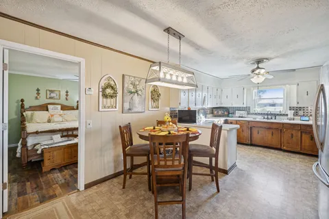 a large kitchen with a table and chairs