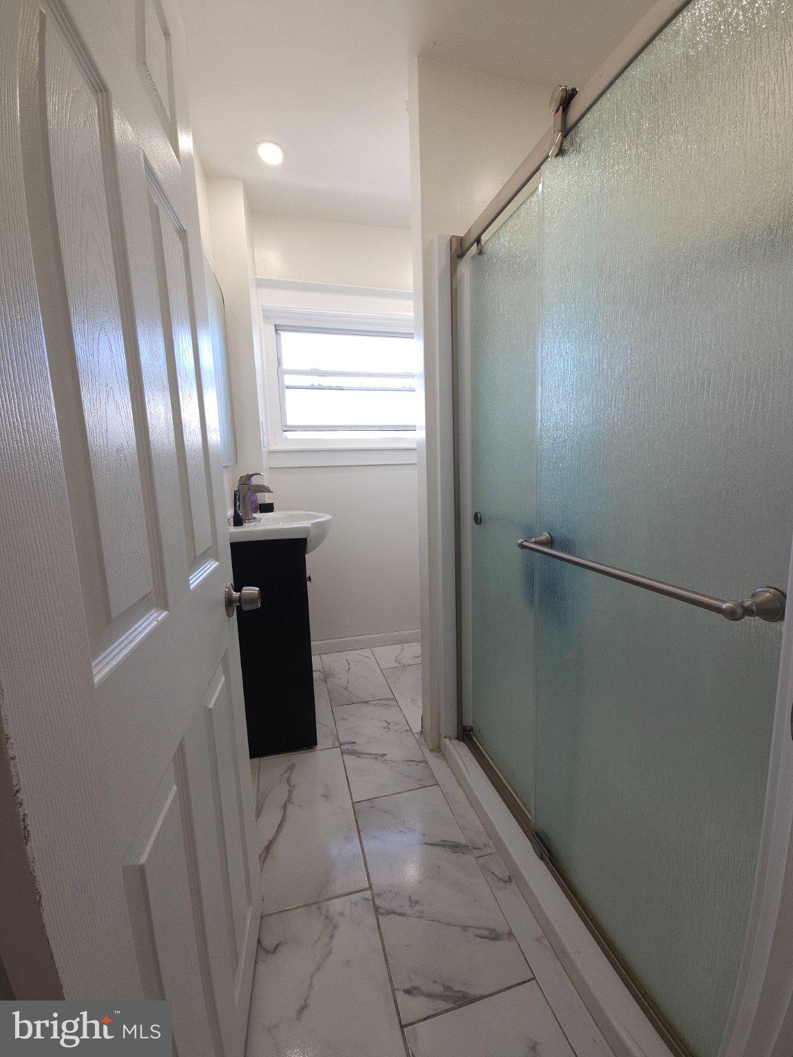 411 South Maple Avenue Lansdowne, PA 19050 - Photo 12 of 18 a bathroom with a granite countertop shower and a sink
