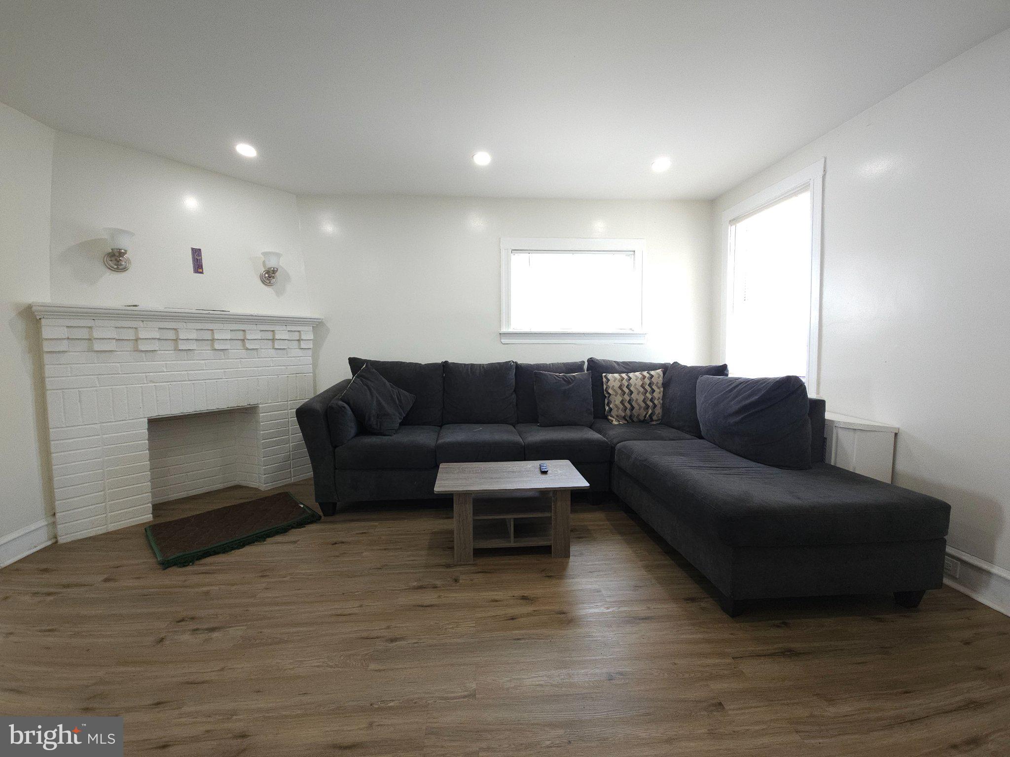 411 South Maple Avenue Lansdowne, PA 19050 - Photo 7 of 18 a living room with furniture and a fireplace