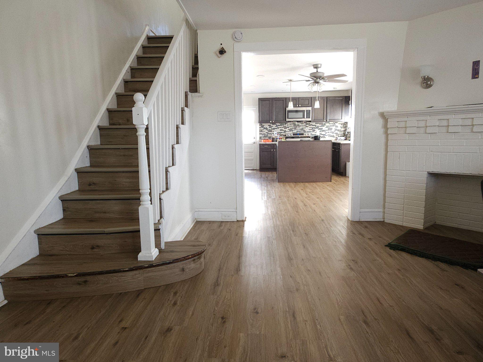 411 South Maple Avenue Lansdowne, PA 19050 - Photo 8 of 18 a view of a room with wooden floor and fireplace