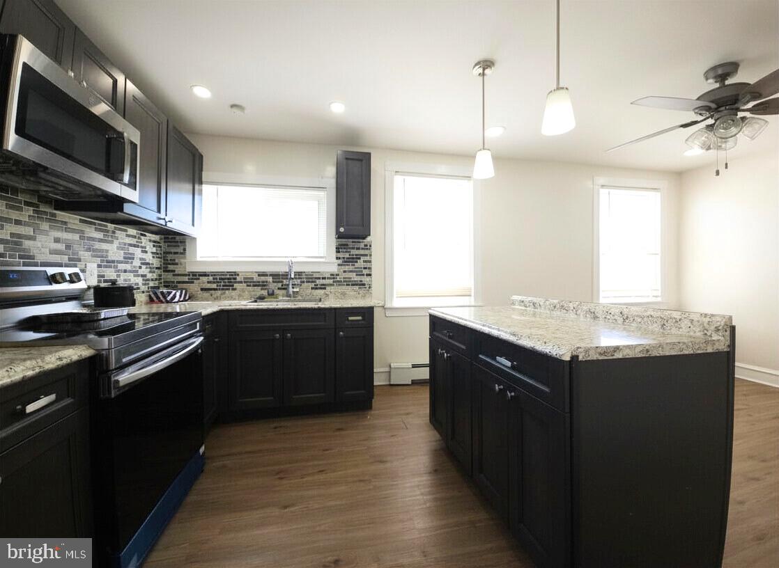 411 South Maple Avenue Lansdowne, PA 19050 - Photo 10 of 18 a kitchen with a sink stove and microwave