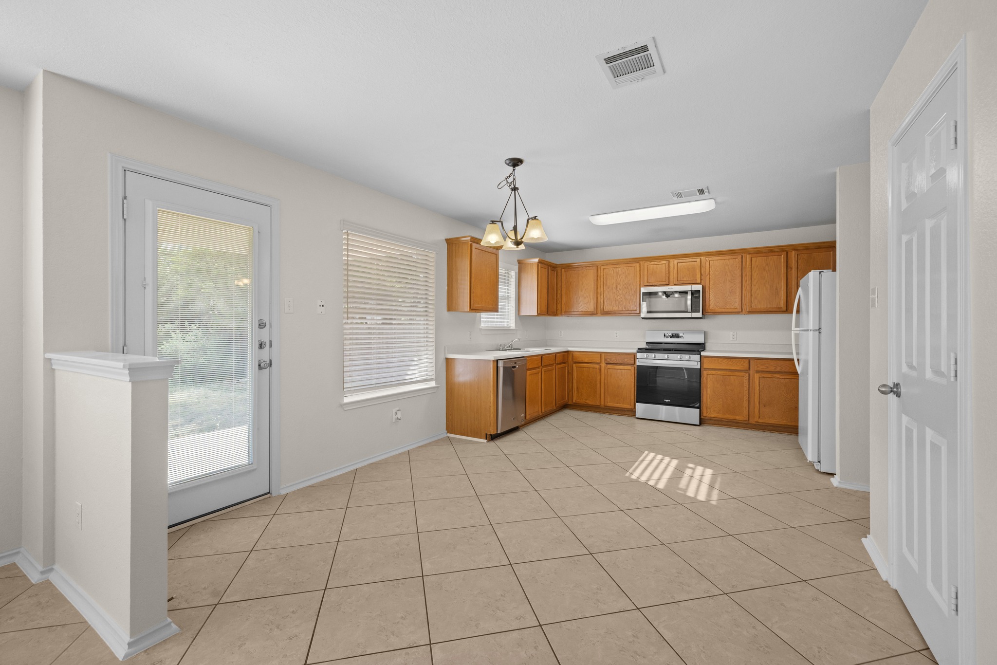 3410 Flowstone Lane Round Rock, TX 78681 - Photo 8 of 38 Functional kitchen with ample cabinet storage, modern appliances, and a bright breakfast nook with access to the backyard through a glass door.