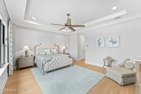 a dining room with furniture a chandelier and wooden floor