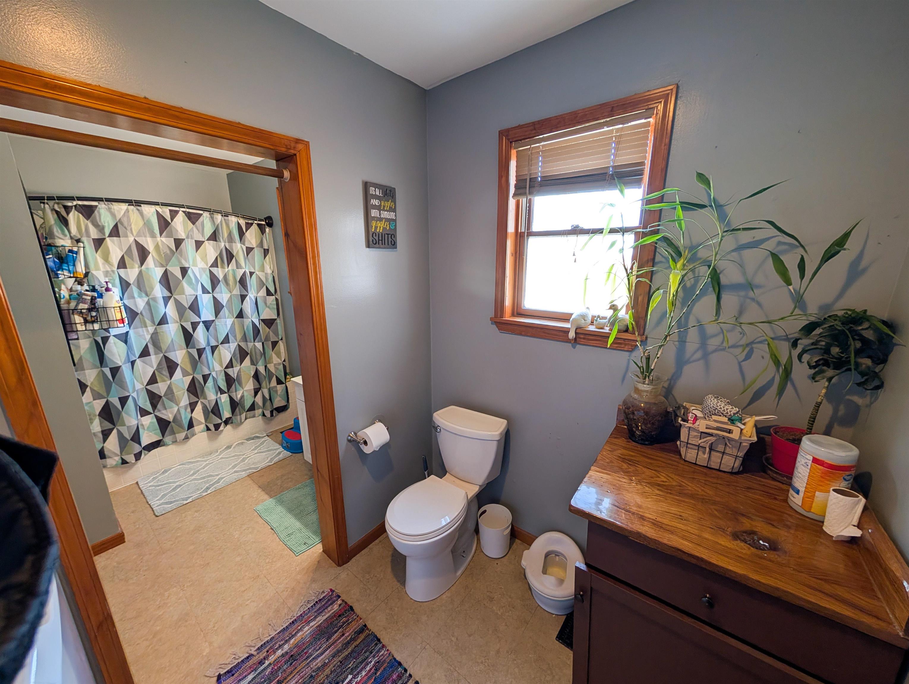 23087 Burr Oak Road Harvard, IL 60033 - Photo 16 of 40 a bathroom with a toilet sink and mirror