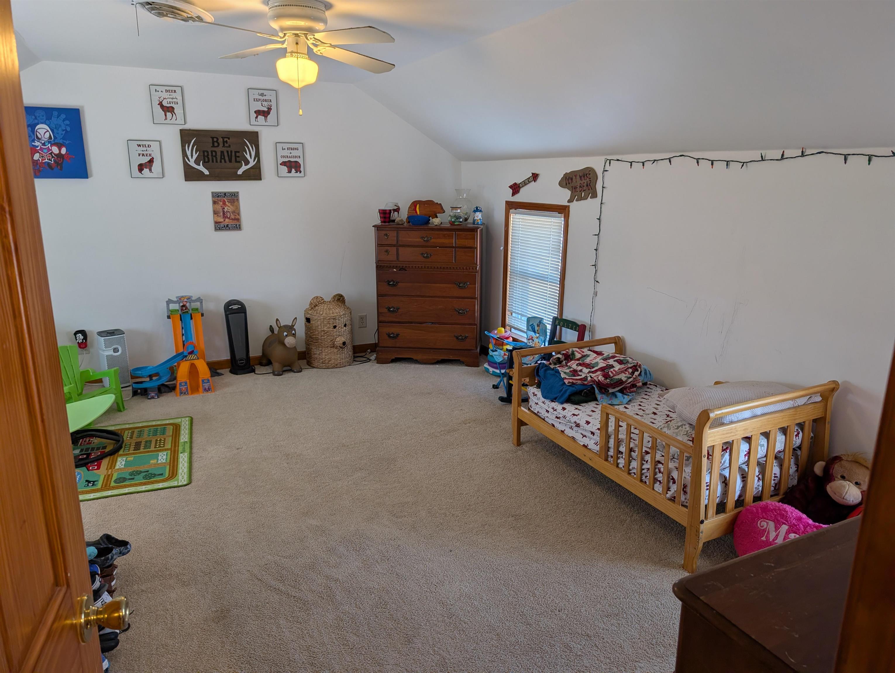 23087 Burr Oak Road Harvard, IL 60033 - Photo 21 of 40 a bedroom with bed and a chandelier